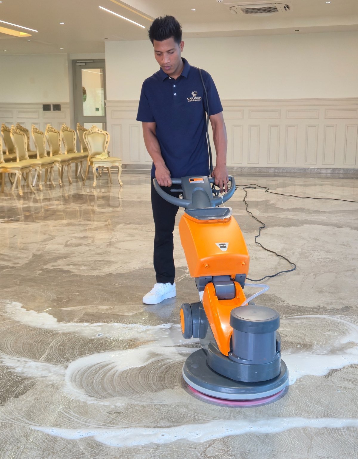 Sevaantha professional carrying out mechanised floor care.